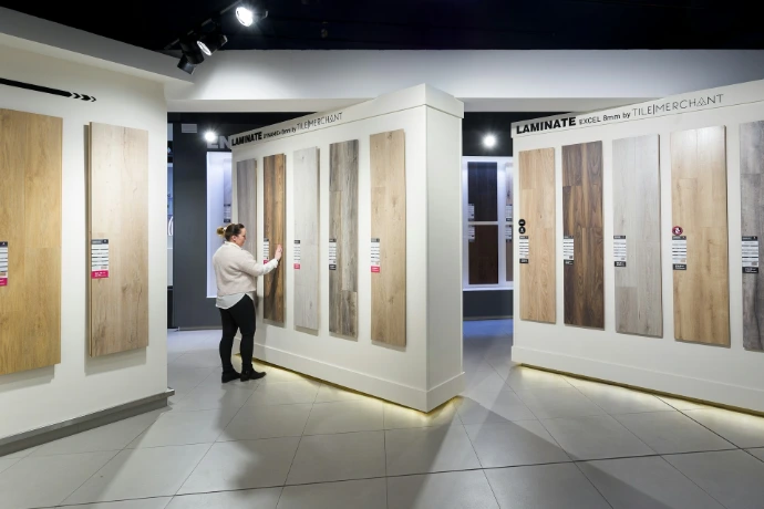 a man standing in front of a display of wooden doors
